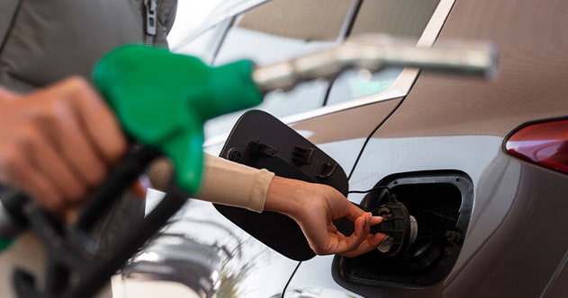 view-woman-with-car-gas-station-min